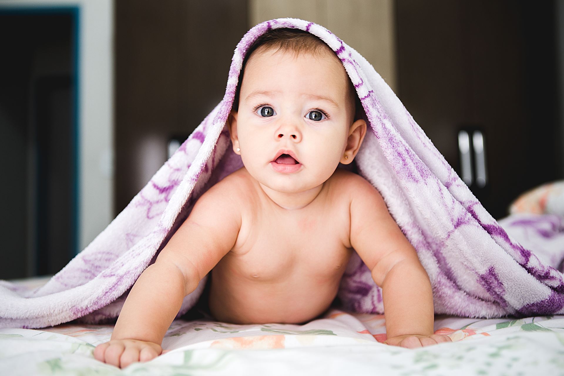 a little girl sitting on a bed