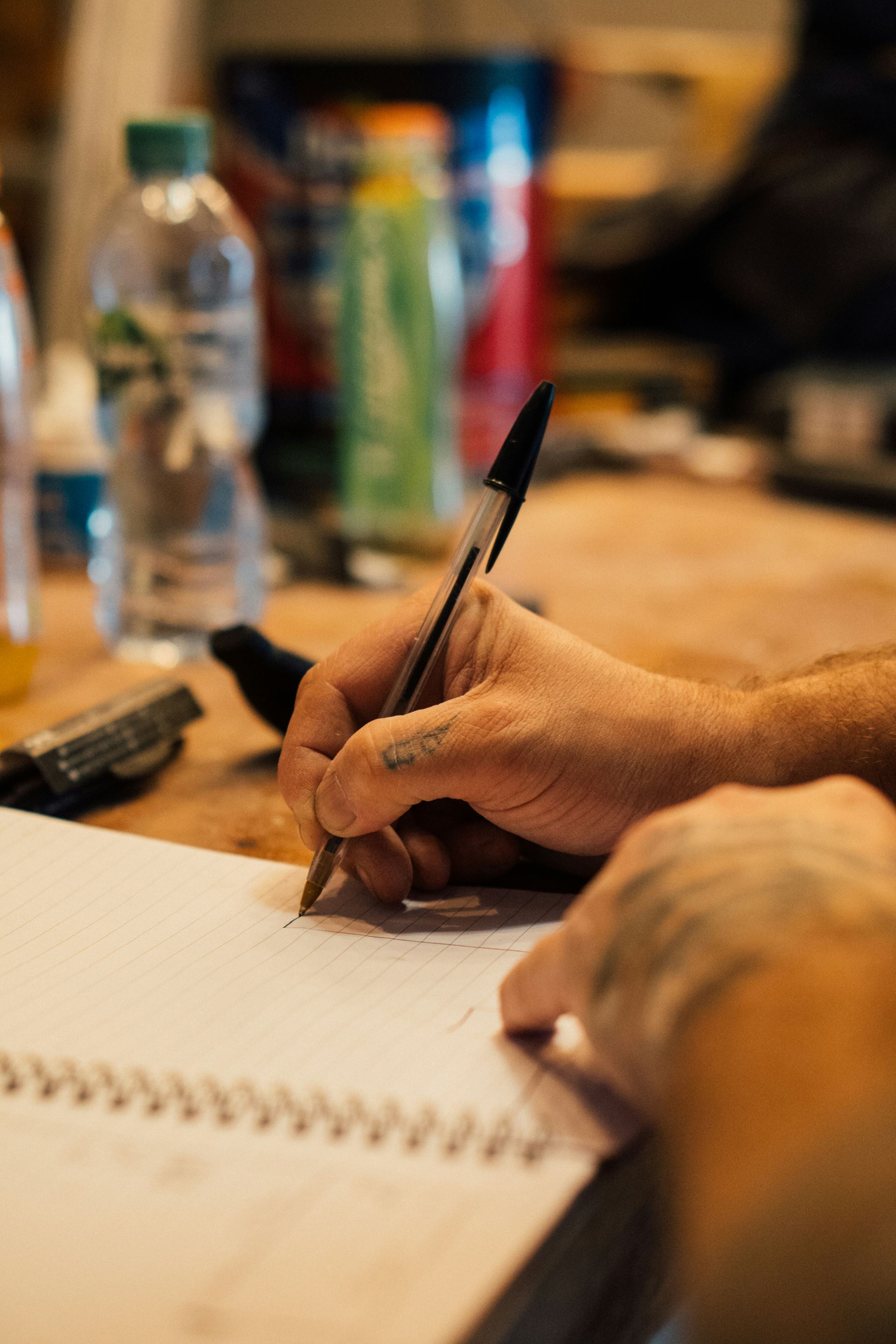 person writing on a piece of paper 